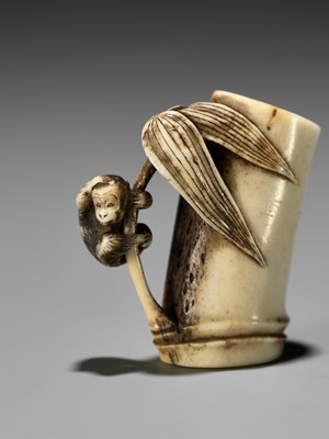 Lot 122 - MASAYUKI: A SUPERB STAG ANTLER NETSUKE OF A MONKEY CLAMBERING ON A LEAFY BAMBOO NODE