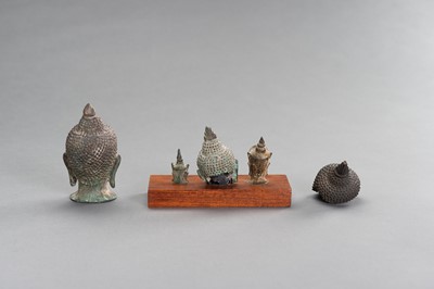 Lot 506 - A LOT WITH FIVE SMALL BRONZE BUDDHA HEADS