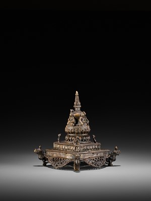 Lot 429 - A BRONZE OPENWORK STUPA WITH THE FOUR CARDINAL BUDDHAS