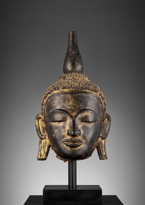Lot 1333 - A LARGE GILT AND BLACK-LACQUERED HEAD OF BUDDHA, AVA STYLE