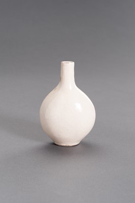 Lot 748 - A MOLDED AND CREAM-GLAZED CERAMIC FLASK, MING DYNASTY