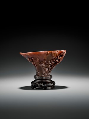Lot 466 - A RHINOCEROS HORN ‘CHILONG AND PRUNUS’ LIBATION CUP, EARLY TO MID-QING
