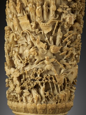 Lot 467 - A CARVED AND RETICULATED CANTON IVORY ‘MYTHICAL BATTLE’ VASE, QING DYNASTY