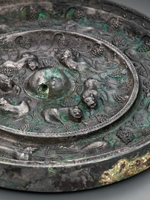 Lot 344 - A SILVERED BRONZE ‘LION AND GRAPEVINE’ MIRROR, TANG DYNASTY