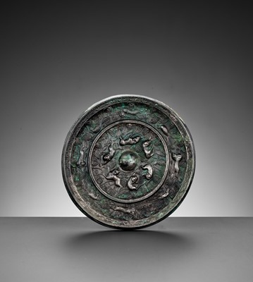 Lot 344 - A SILVERED BRONZE ‘LION AND GRAPEVINE’ MIRROR, TANG DYNASTY