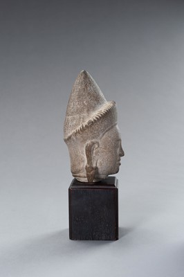 Lot 1332 - A MUSEUM COPY OF A KHMER STONE HEAD