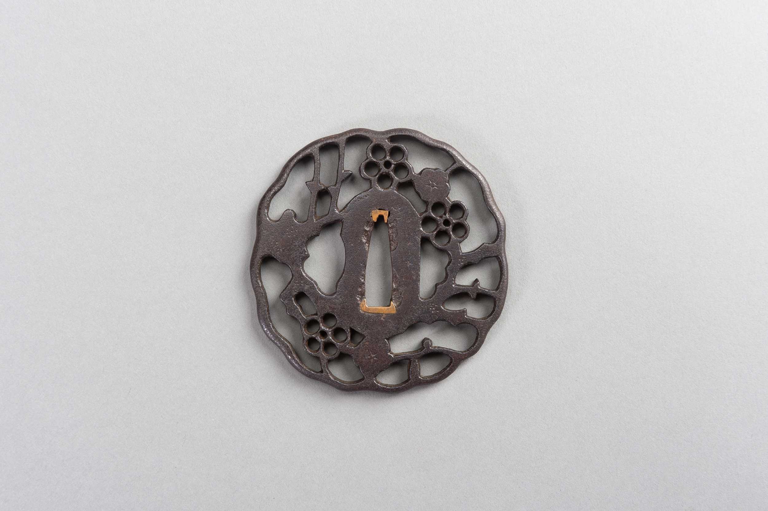 Lot 44 - AN IRON SUKASHI-TSUBA WITH FLOWERS AND CLOUDS