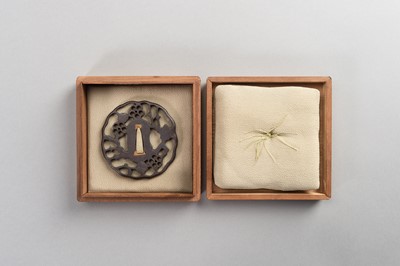Lot 44 - AN IRON SUKASHI-TSUBA WITH FLOWERS AND CLOUDS
