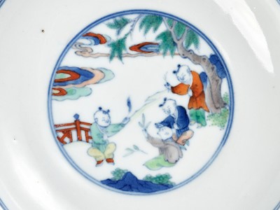 Lot 424 - A MAGNIFICENT PAIR OF DOUCAI ‘BOYS’ DISHES, YONGZHENG MARKS AND OF THE PERIOD