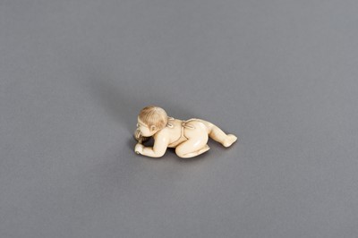 Lot 408 - MASATSUGU: A FINE IVORY NETSUKE OF A CRAWLING INFANT