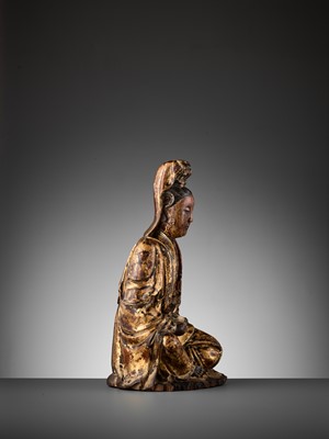 Lot 401 - A CARVED AND GILT-LACQUERED WOOD FIGURE OF GUANYIN, MING DYNASTY