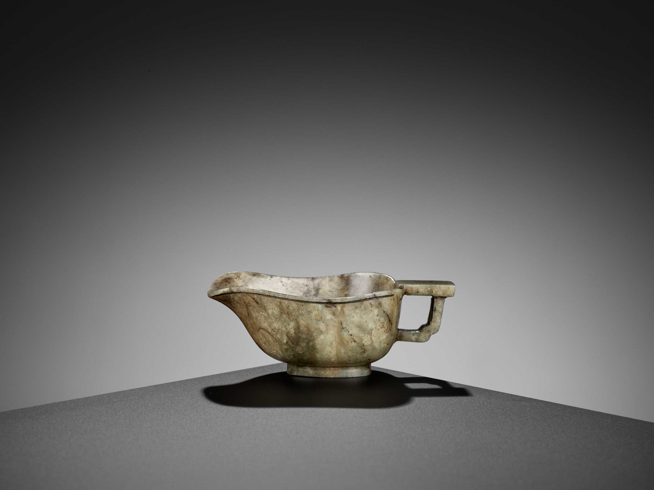 Lot 114 - A GRAY JADE ‘ARCHAISTIC’ POURING VESSEL, YI, EARLY QING DYNASTY