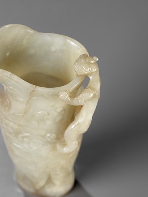 Lot 346 - AN IMPERIAL CELADON AND RUSSET JADE ‘CHILONG’ RHYTON, QIANLONG MARK AND PERIOD
