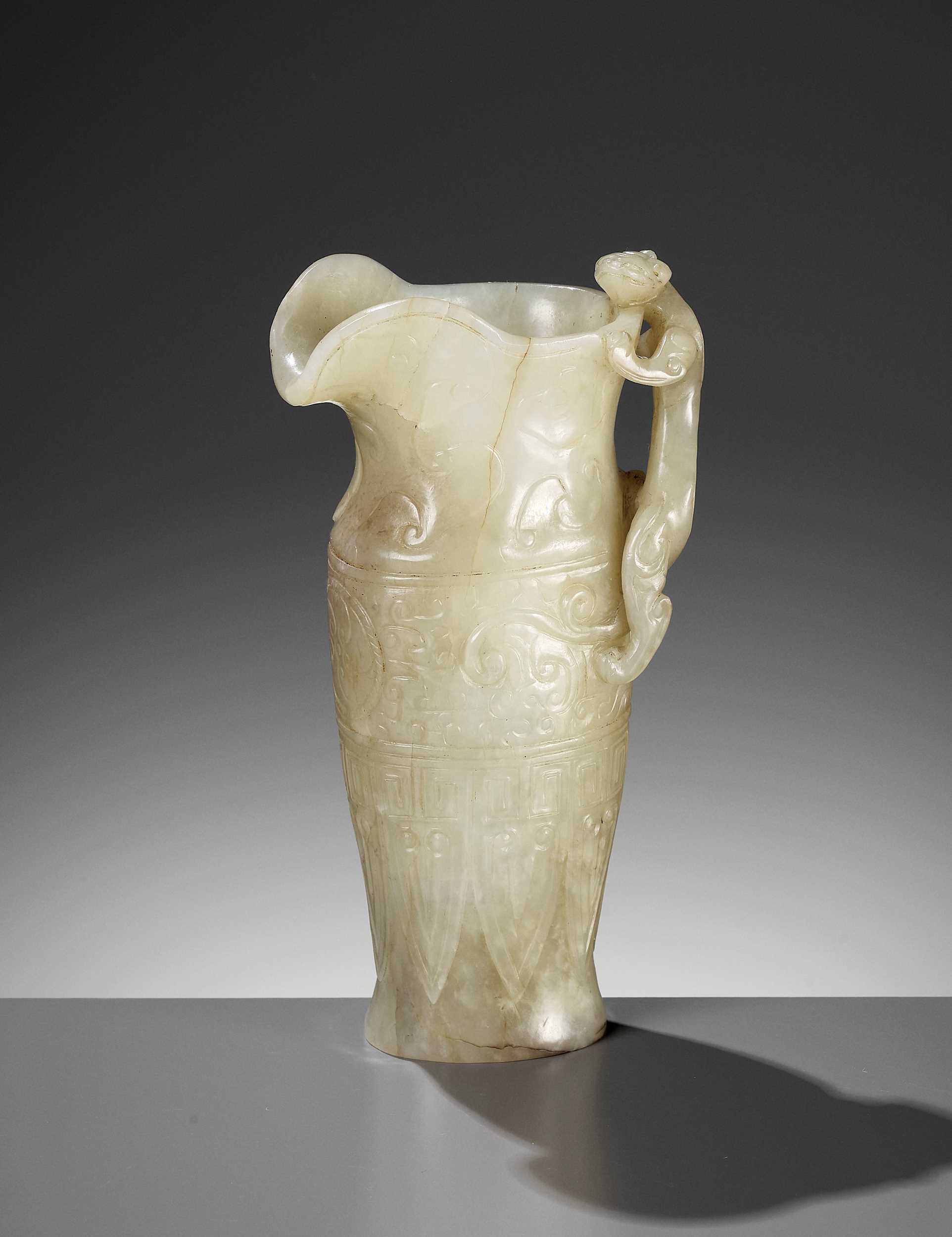 Lot 346 - AN IMPERIAL CELADON AND RUSSET JADE ‘CHILONG’ RHYTON, QIANLONG MARK AND PERIOD
