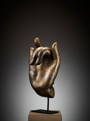 Lot 402 - A MASSIVE LACQUER-GILT COPPER REPOUSSÉ ‘KARANA MUDRA’ HAND OF BUDDHA, MING TO EARLY QING