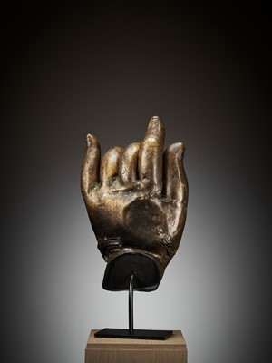 Lot 402 - A MASSIVE LACQUER-GILT COPPER REPOUSSÉ ‘KARANA MUDRA’ HAND OF BUDDHA, MING TO EARLY QING