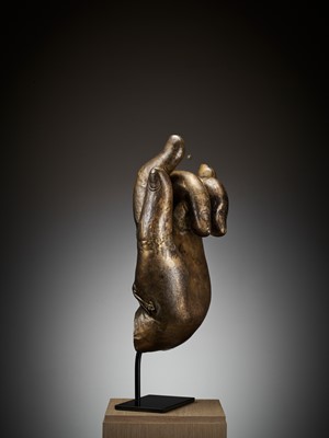 Lot 402 - A MASSIVE LACQUER-GILT COPPER REPOUSSÉ ‘KARANA MUDRA’ HAND OF BUDDHA, MING TO EARLY QING