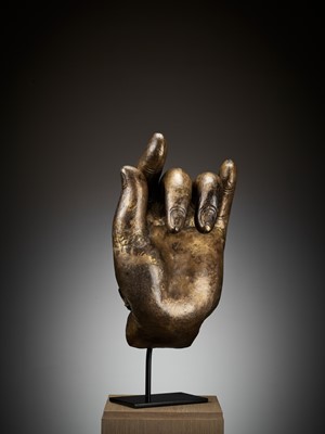 Lot 402 - A MASSIVE LACQUER-GILT COPPER REPOUSSÉ ‘KARANA MUDRA’ HAND OF BUDDHA, MING TO EARLY QING