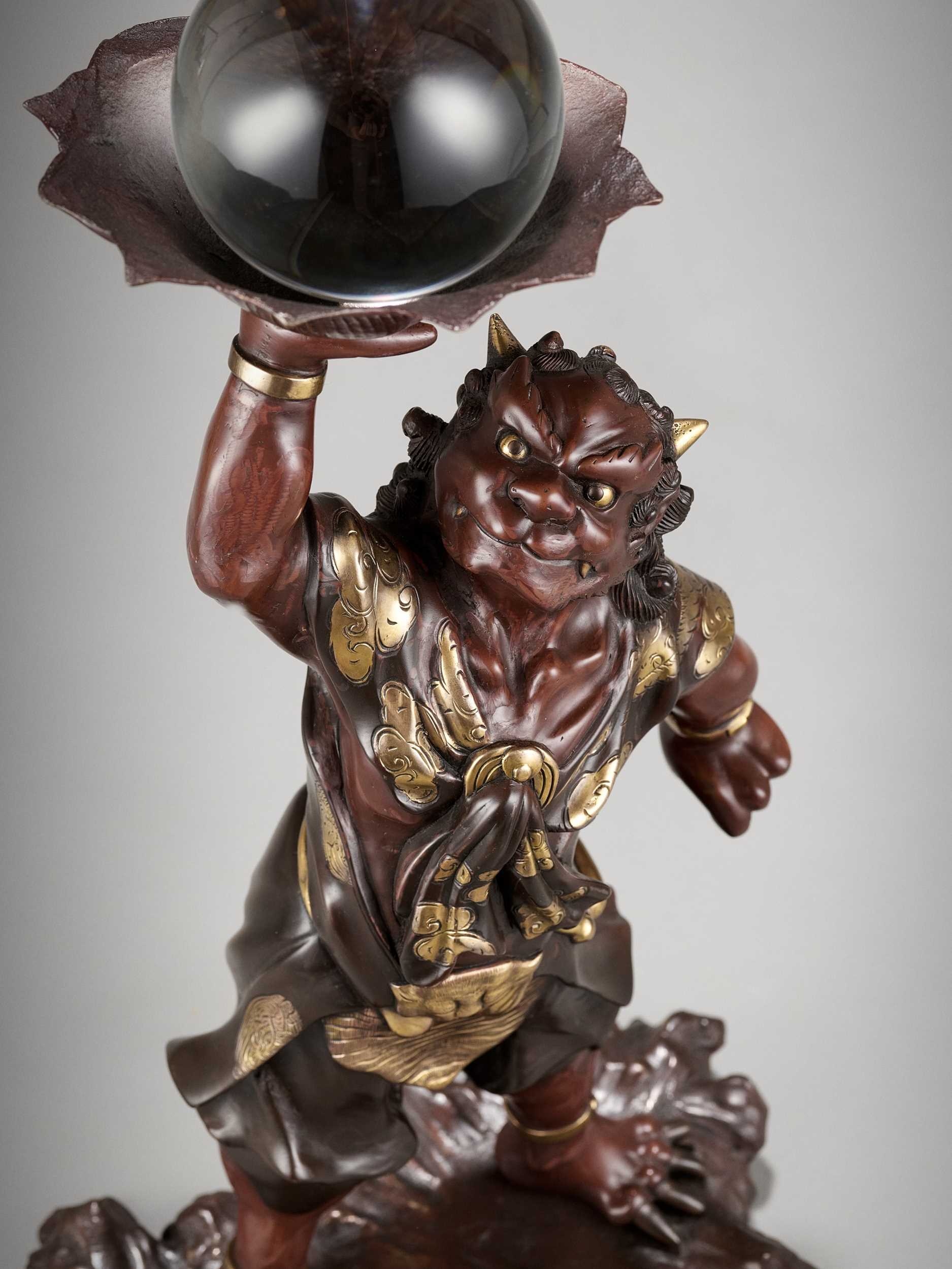 Lot 12 - A LARGE PARCEL-GILT BRONZE MIYAO STYLE FIGURE OF AN ONI WITH ROCK CRYSTAL BALL