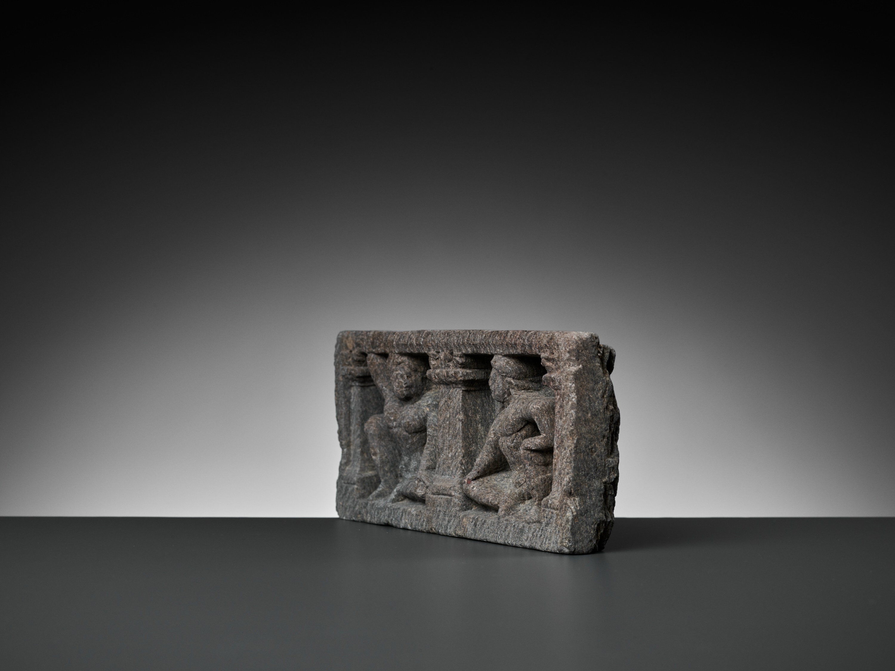 Lot 547 - A GRAY SCHIST RELIEF WITH TWO ATLAS FIGURES,