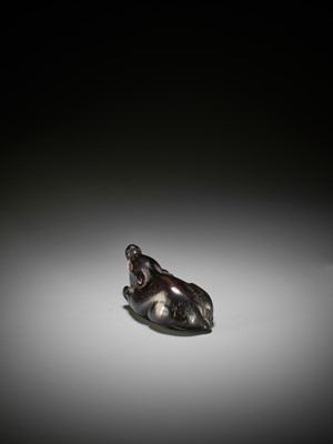 Lot 38 - A LARGE AND OLD DARK WOOD NETSUKE OF A RECUMBENT BOAR