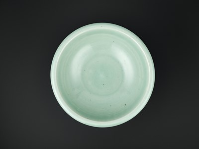 Lot 260 - A LARGE MOLDED AND INCISED CELADON-GLAZED BOWL, MID-QING