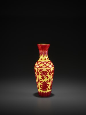 Lot 19 - A RED-OVERLAY YELLOW GLASS ‘BAJIXIANG’ VASE, MID-QING