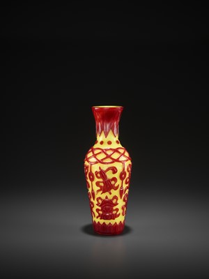 Lot 19 - A RED-OVERLAY YELLOW GLASS ‘BAJIXIANG’ VASE, MID-QING