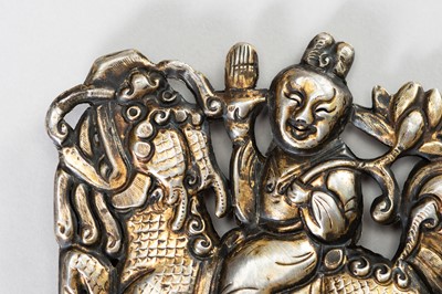 Lot 68 - A PARCEL GILT SILVER REPOUSSÉ ORNAMENT OF GUANYIN ON A BUDDHIST LION