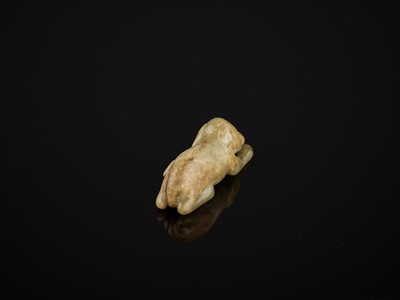 Lot 85 - A CELADON AND RUSSET JADE FIGURE OF A DOG, SONG TO MING DYNASTY