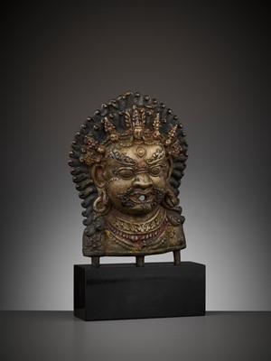 Lot 418 - A GILT BRONZE MASK OF BHAIRAVA, 16TH-17TH CENTURY