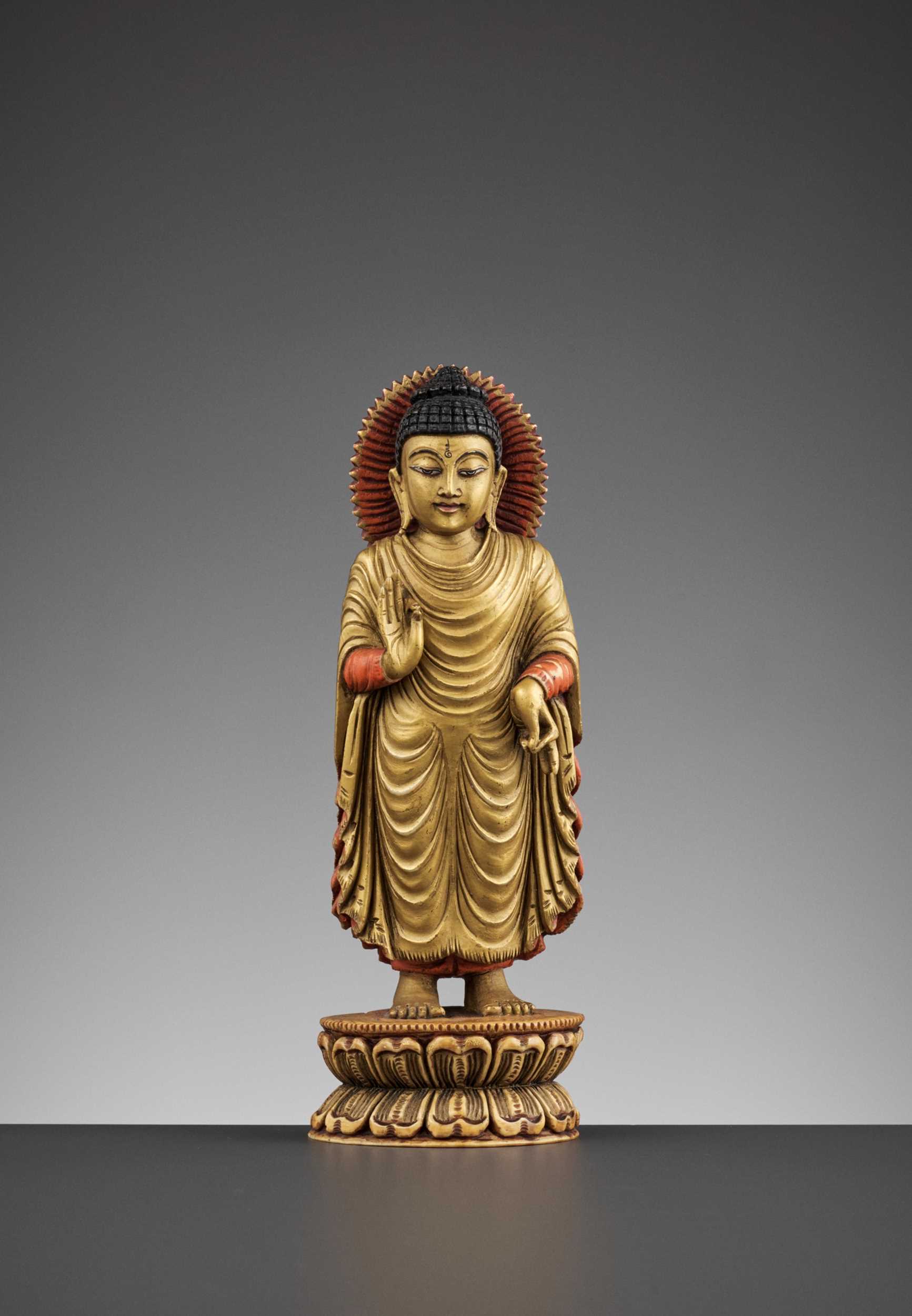 Lot 86 - A TIBETAN-CHINESE PAINTED AND GILT IVORY FIGURE OF BUDDHA, LATE MING TO EARLY QING DYNASTY