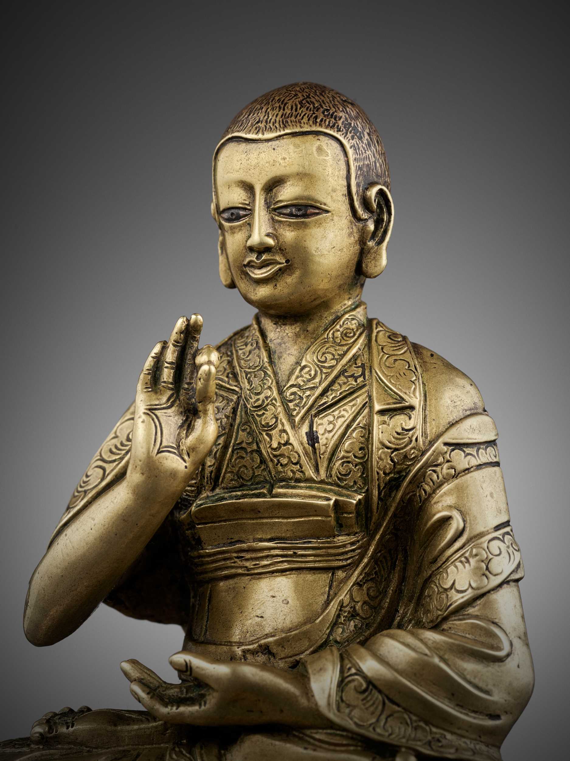 Lot 391 - A SILVER-INLAID BRONZE FIGURE OF LOWO KHENCHEN SONAM LHUNDRUP, ABBOT OF THE KINGDOM OF LO