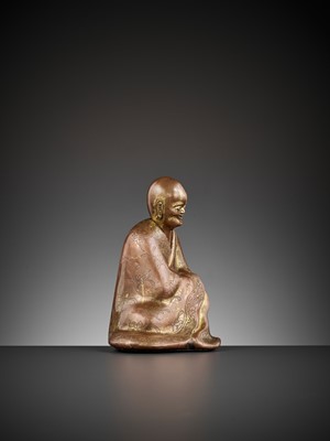 Lot 82 - A GILT COPPER ALLOY FIGURE OF A LUOHAN, 17TH CENTURY