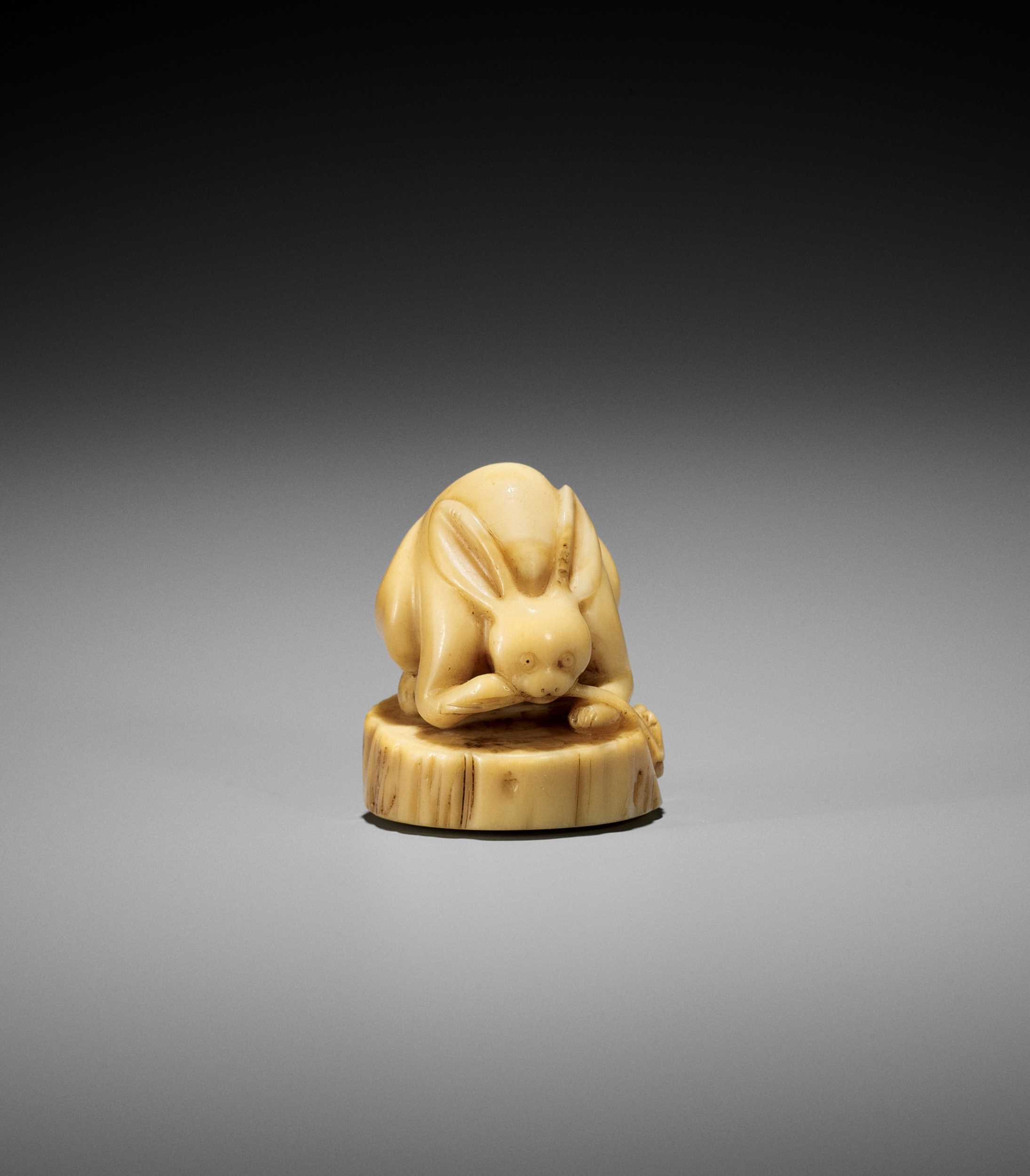 A VERY RARE NARWHAL TUSK NETSUKE OF A RABBIT WITH REISHI