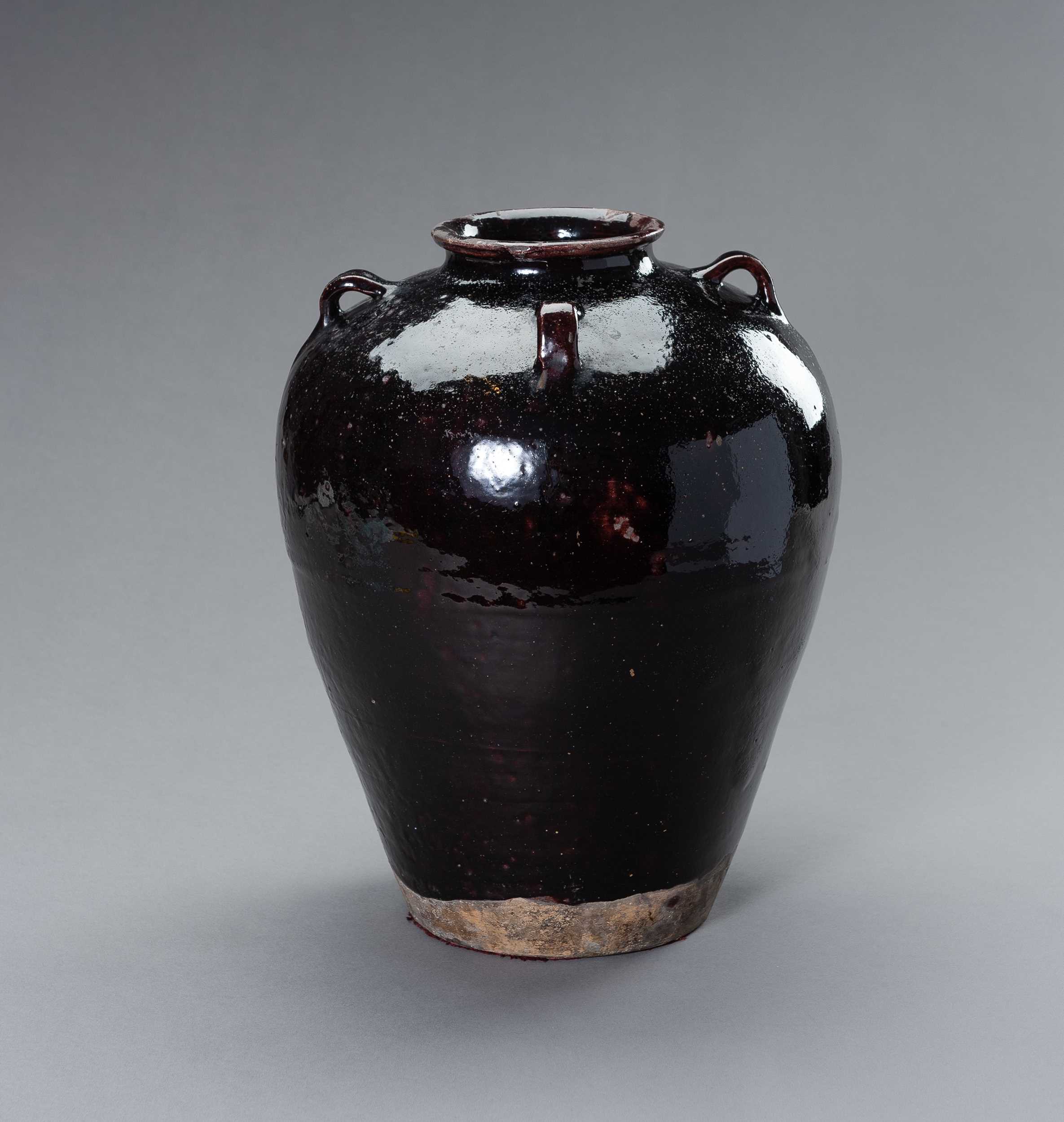 Lot 698 - A LARGE AUBERGINE GLAZED MARTABAN STORAGE JAR