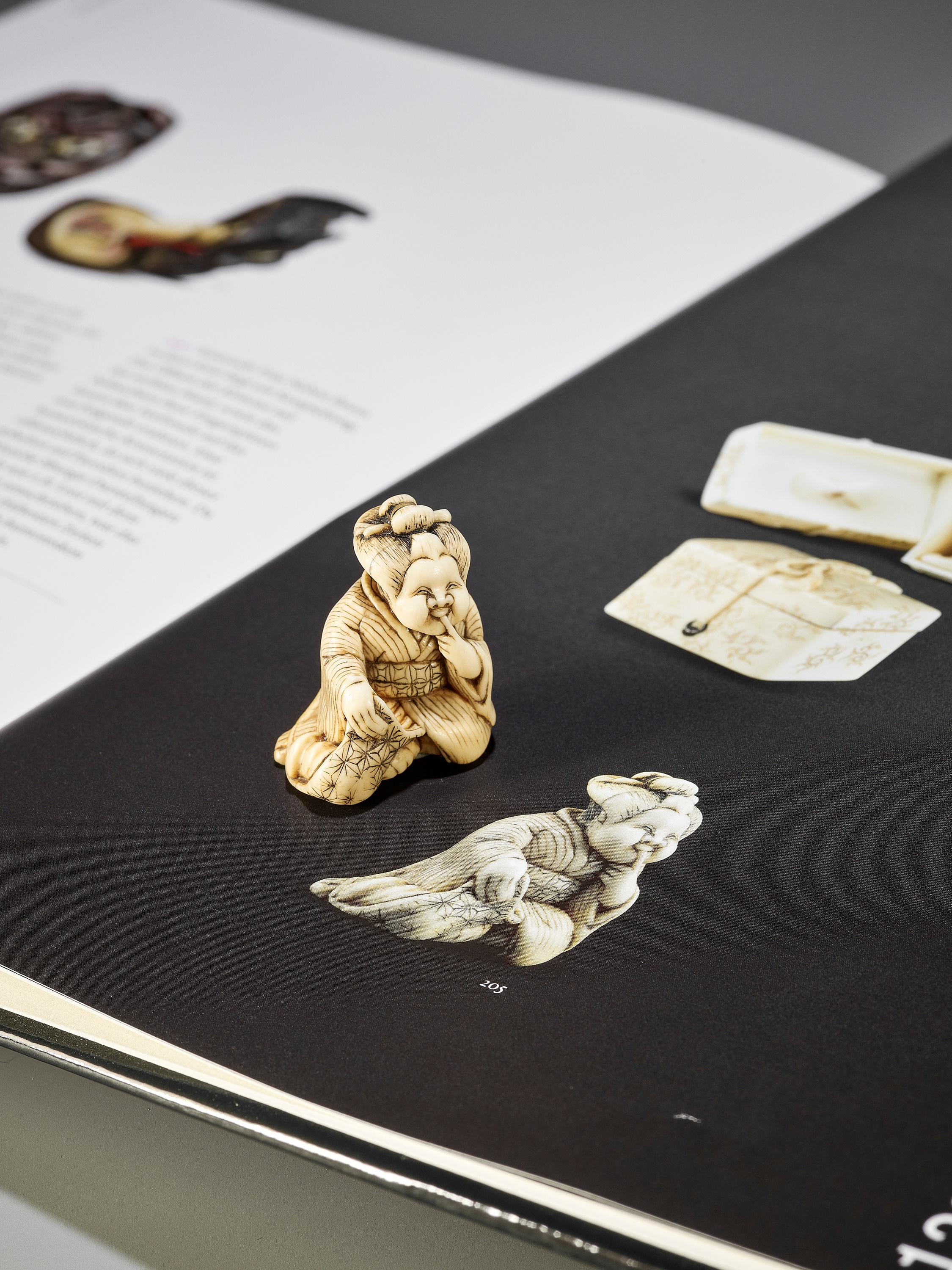 Lot 97 - A RARE IVORY SHUNGA NETSUKE OF OKAME WITH