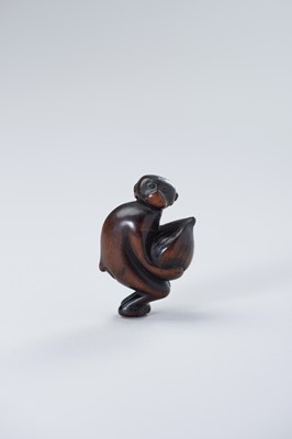Lot 453 - TWO WOOD NETSUKE OF A MONKEY WITH CHESTNUT