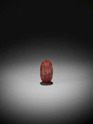 Lot 306 - A FINE TSUISHU (CARVED RED LACQUER) MANJU NETSUKE WITH LILIES