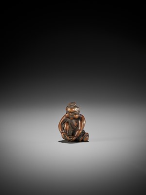Lot 147 - A CHARMING OLD WOOD NETSUKE OF OKAME CLIPPING HER TOENAILS