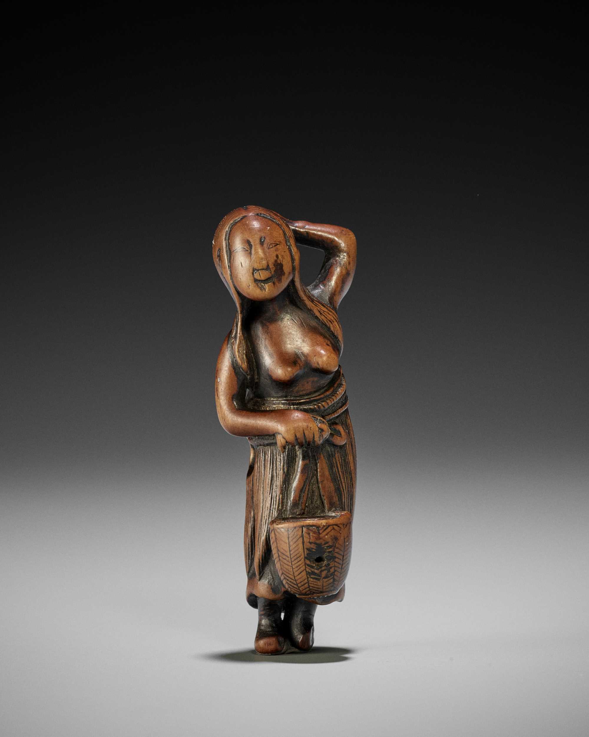 Lot 20 - AN OLD WOOD NETSUKE OF A DIVING GIRL (AMA)