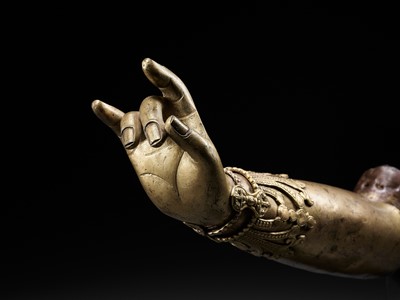 Lot 400 - A TIBETAN-CHINESE GILT COPPER-ALLOY ARM OF A BODHISATTVA, LATE MING TO EARLIER QING