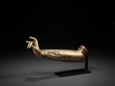 Lot 400 - A TIBETAN-CHINESE GILT COPPER-ALLOY ARM OF A BODHISATTVA, LATE MING TO EARLIER QING
