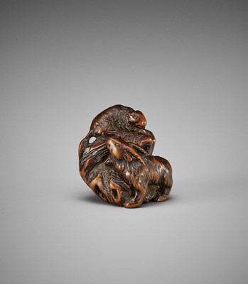 KOKEI: A RARE WOOD NETSUKE OF A GOAT AND YOUNG ON A ROCK