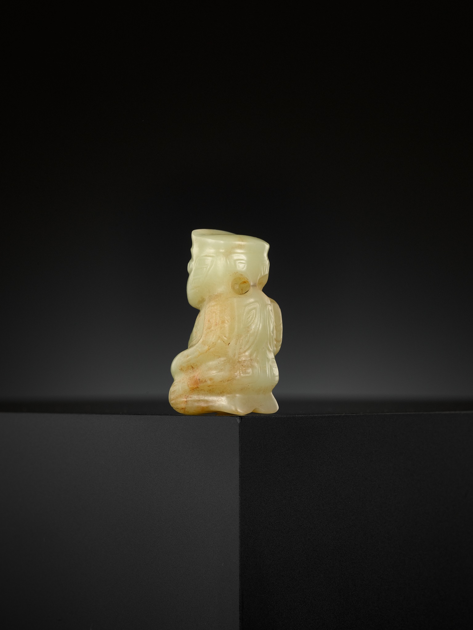 A beige and brown jade figure of a bixie, Ming dynasty or