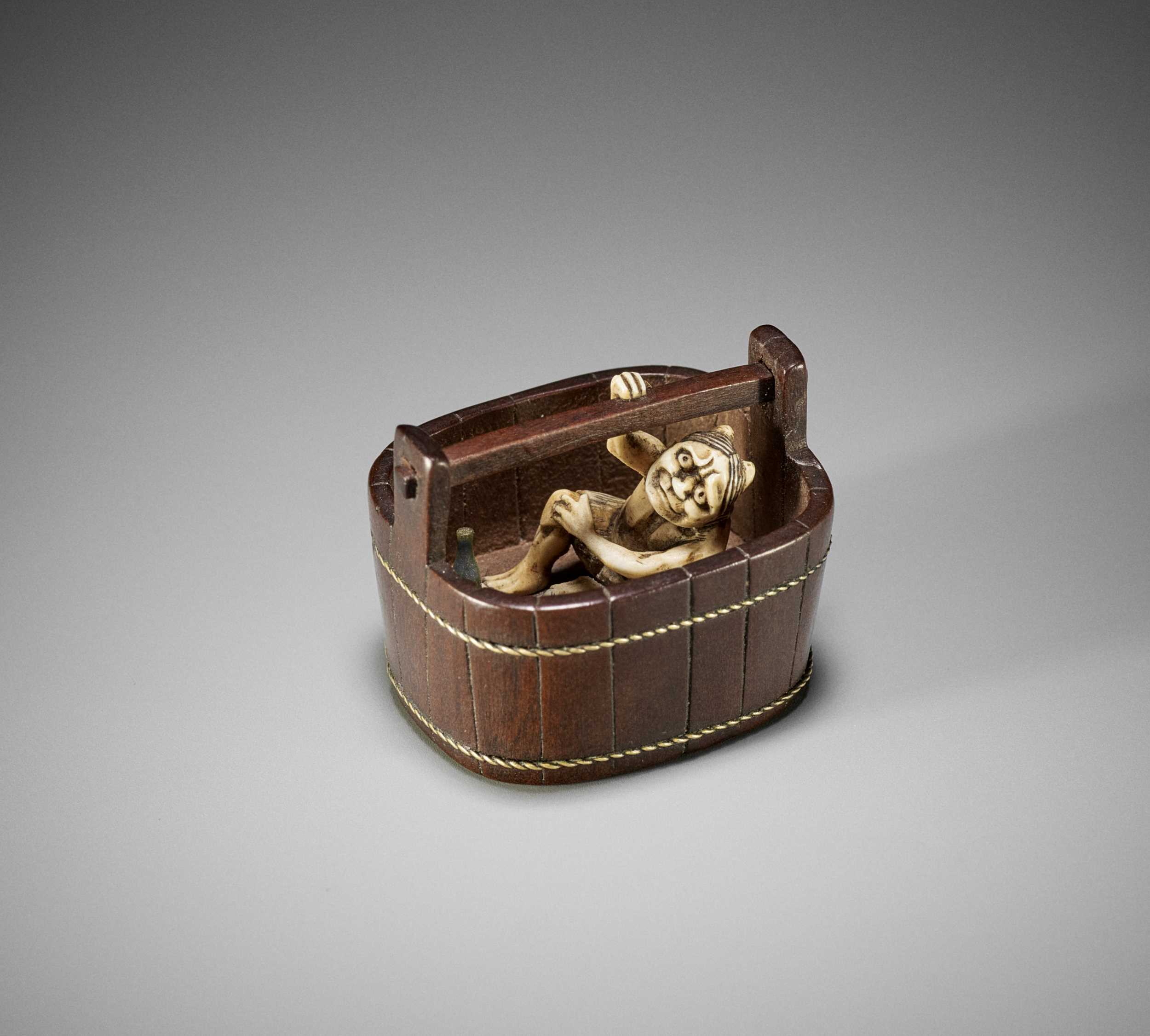 Lot 208 - A FINE TOKOKU STYLE MIXED MATERIAL NETSUKE OF AN ONI IN A BUCKET