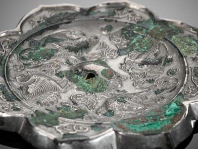 Lot 43 - AN OCTAFOIL SILVERED BRONZE ‘BIRDS AND FLOWERS’ MIRROR, TANG DYNASTY