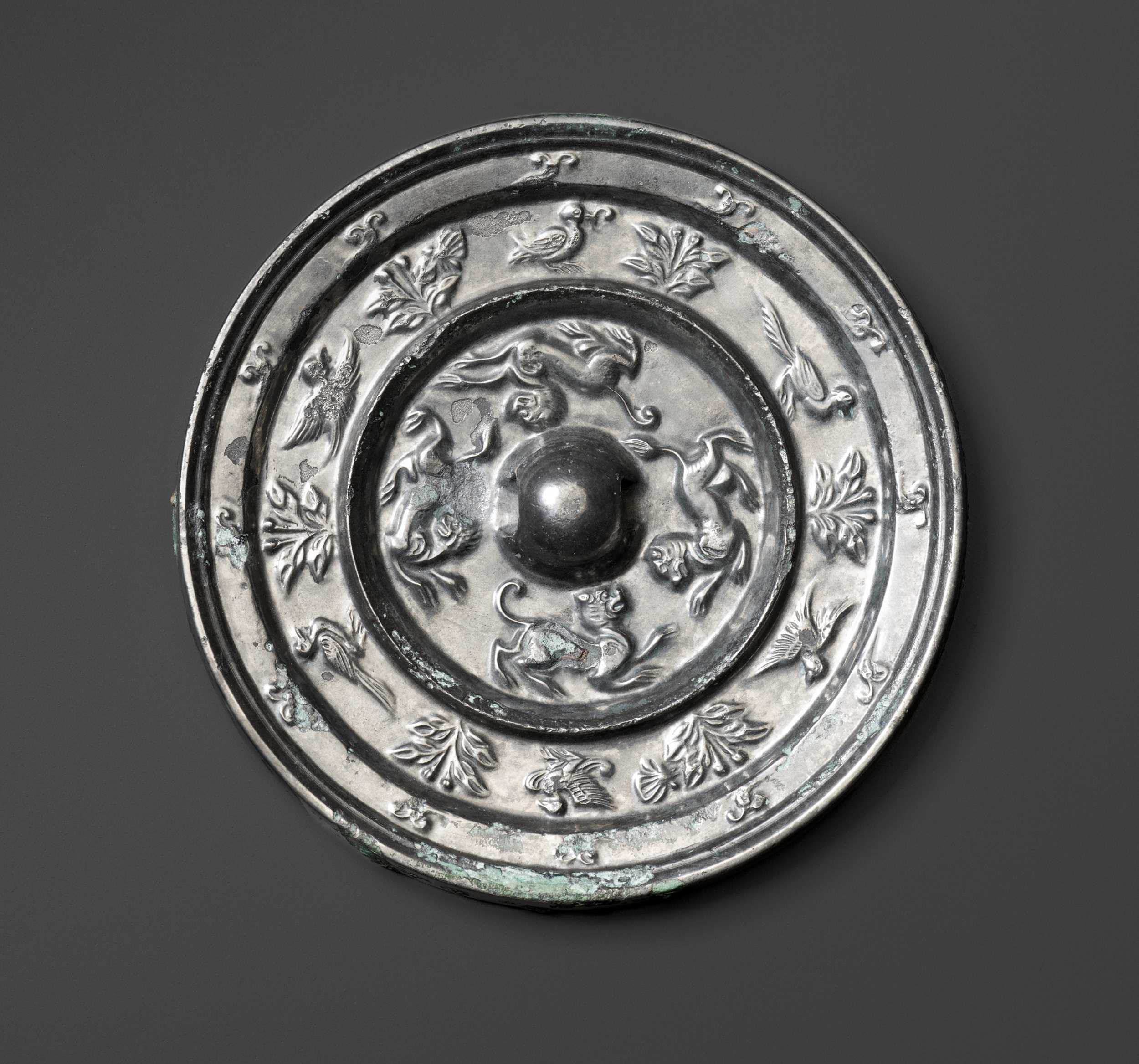 Lot 42 - A SILVERED BRONZE ‘MYTHICAL BEASTS’ MIRROR, TANG DYNASTY