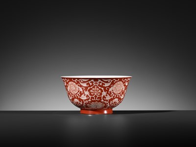 Lot 507 - A PAIR OF REVERSE-DECORATED CORAL-GROUND ‘PEONY AND LOTUS’ BOWLS, QIANLONG SEAL MARKS AND OF THE PERIOD