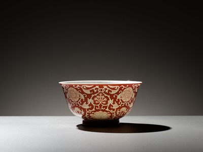 Lot 507 - A PAIR OF REVERSE-DECORATED CORAL-GROUND ‘PEONY AND LOTUS’ BOWLS, QIANLONG SEAL MARKS AND OF THE PERIOD